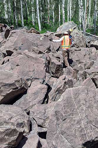 Surveyor on boulders